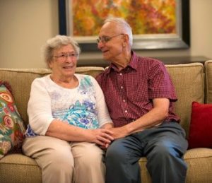 couple-sitting-together-on-couch-smiling-340